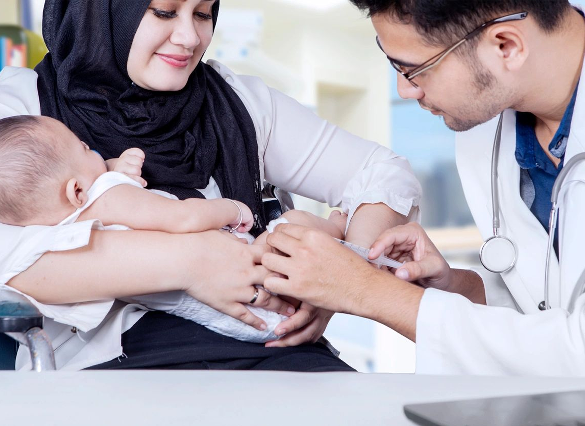 Mother holding baby at doctor's office