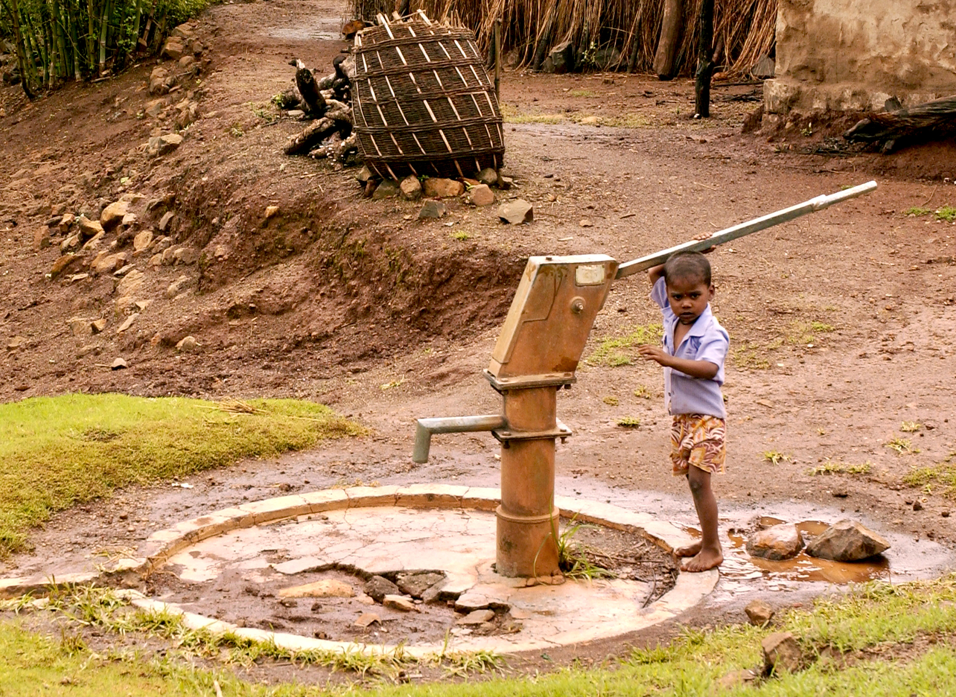 Child using a hand water pump